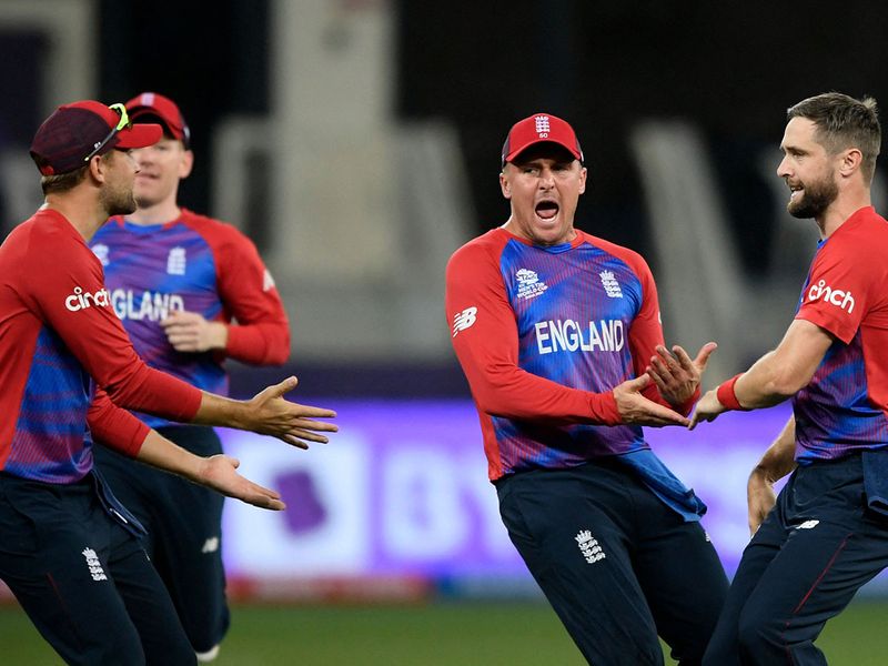 England's Chris Woakes celebrates the wicket of Australia's David Warner