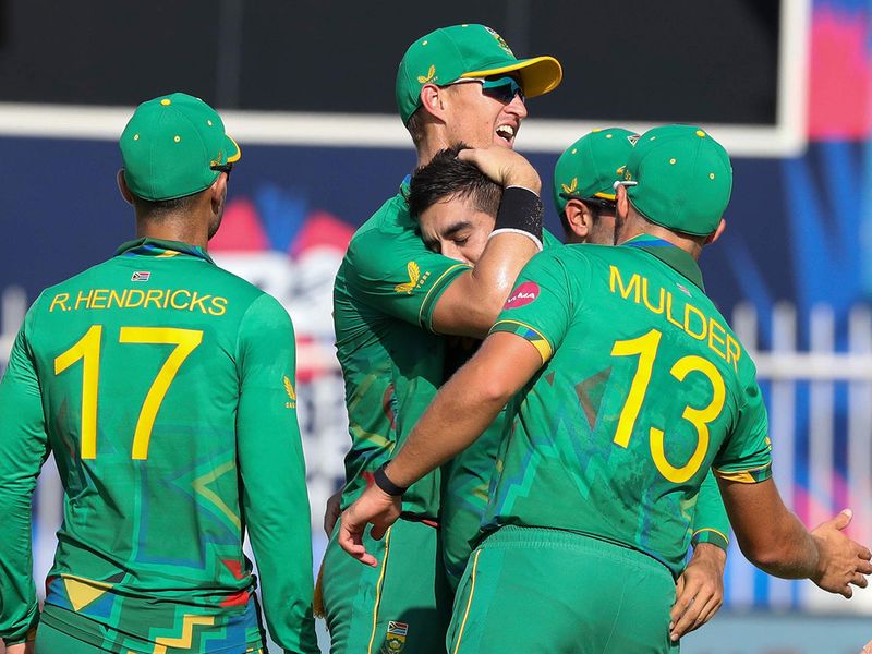 South Africa's Tabraiz Shamsi, centre, is embraced by teammates 