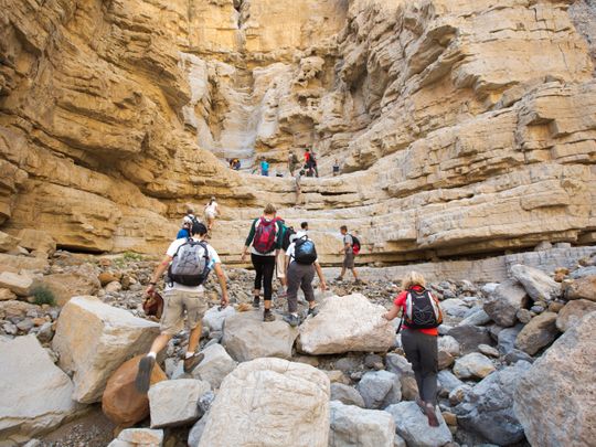 Group of hikers walking in the mountains in Ras Al Khaimah
