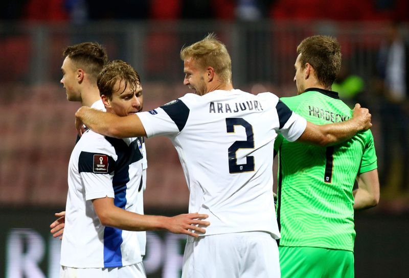 Finland players celebrate at the end of the win over Bosnia