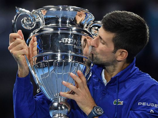 Serbia's Novak Djokovic celebrates with the ATP No. 1 player trophy after winning to Norway's Casper Ruud during their single match of ATP Finals in Turin