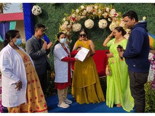 Health teams giving a letter of appreciation to the family that organised a blood donation camp during their daughter's wedding.