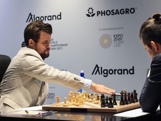 Norway's chessmaster Magnus Carlsen competes against Russia's chessmaster Ian Nepomniachtchi during Game 2 of the FIDE World Chess Championship Dubai 2021, at Expo 2020 Dubai