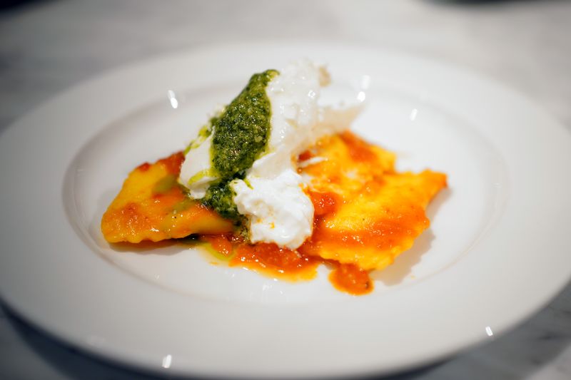 Add a scoop burrata cheese on top, and a tablespoon of pesto to garnish.