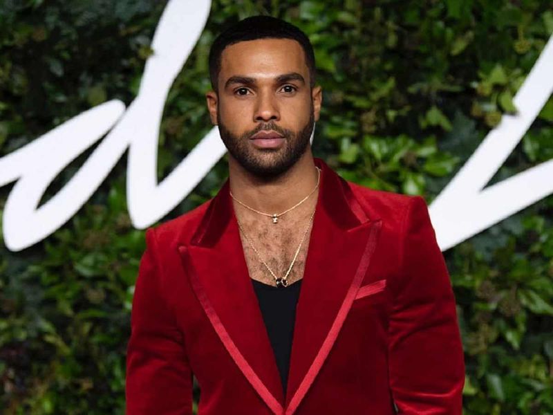 Actor Lucien Laviscount made a bold statement in a striking a low-slung t-shirt and burgundy blazer 