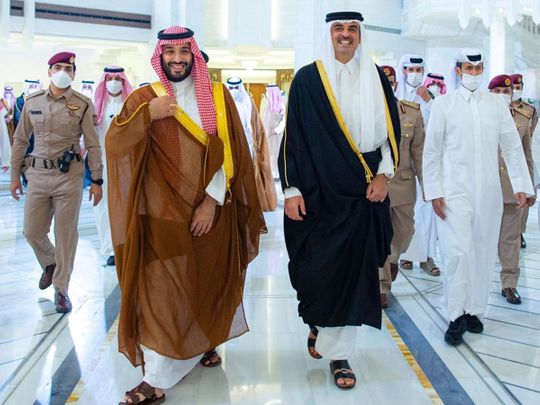 Saudi Crown Prince Mohammed bin Salman is received by Qatar's Emir Sheikh Tamim bin Hamad Al Thani in Doha on December 8, 2021. 