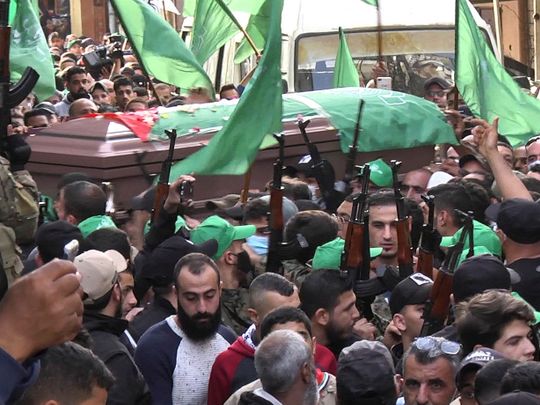 Members of Palestinian group Hamas carry their weapons during the funeral of a man who was killed in an explosion that occurred on Friday night in the Palestinian camp of Burj al-Shemali, in southern Lebanese port city of Tyre, Lebanon December 12, 2021. REUTERS/Ali Hankir   NO RESALES. NO ARCHIVES.