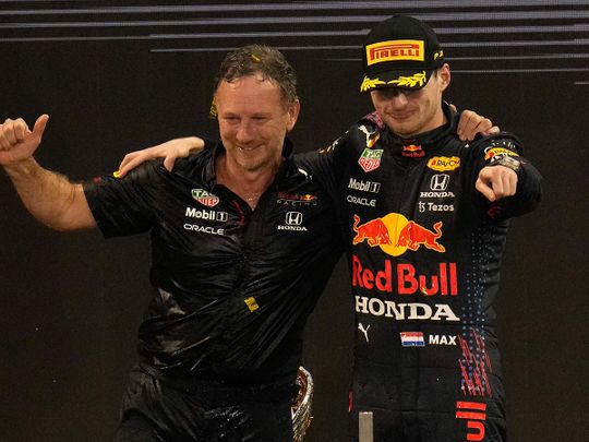 Red Bull team chief Christian Horner, left, celebrates with his driver Max Verstappen of the Netherlands after winning the Formula One Abu Dhabi Grand Prix in Abu Dhabi, United Arab Emirates, Sunday, Dec. 12, 2021. Max Verstappen ripped a record eighth title away from Lewis Hamilton with a pass on the final lap of the Abu Dhabi GP to close one of the most thrilling Formula One seasons in years as the first Dutch world champion. (AP Photo/Hassan Ammar)
