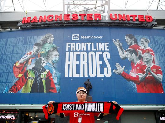 A fan outside Old Trafford before the game against Brentford was called off