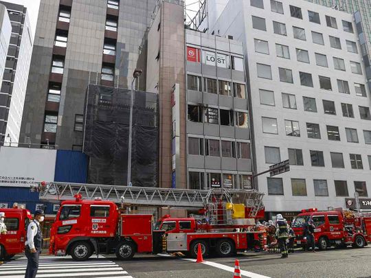 Firetrucks are seen in front of a building where a fire broke out in Osaka, western Japan December 17, 2021 in this photo taken by Kyodo.