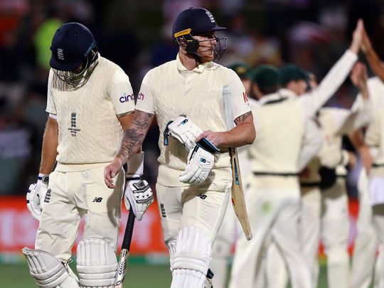 England's Joe Root, left, and Ben Stokes leave the field 