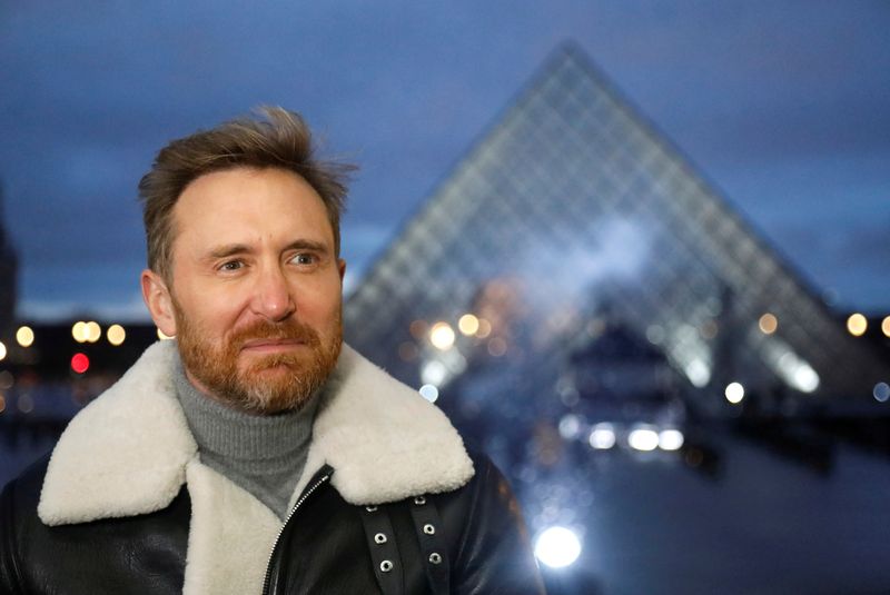 French DJ David Guetta poses in front of the Louvre Pyramid before performing the 'United at Home' fundraising live concert for New Year's Eve, in Paris, France, December 29, 2020. Picture taken December 29, 2020.  REUTERS/Charles Platiau