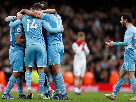 Manchester City's Spanish midfielder Rodri celebrates with teammates after winner over Arsenal 