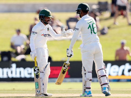 Bangladesh's batsmen Mominul Haque and Liton Das bump gloves at the Bay Oval in Mount Maunganui 