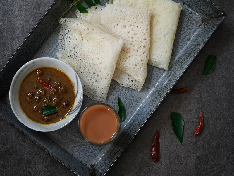 Neer dosas are often accompanied with some non-vegetarian options, like chicken or fish curry, or a coconut chutney