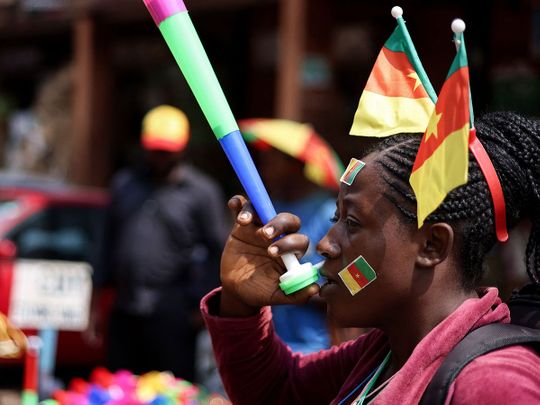 A street vendor blows on a vuvuzela at the central market in Yaounde ahead of the African Cup of Nations 