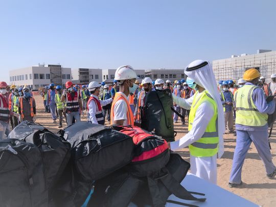 Workers recieve bags of winter clothes in the 'Warm Winter' campaign in Sharjah 