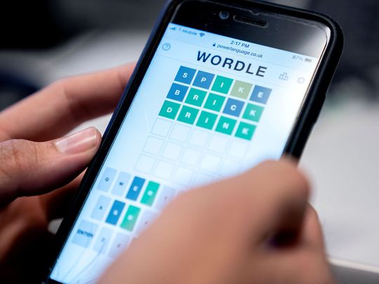 This photo illustration shows a person playing online word game “Wordle” on a mobile phone in Washington, DC on January 11, 2022. (Photo by Stefani Reynolds / AFP)