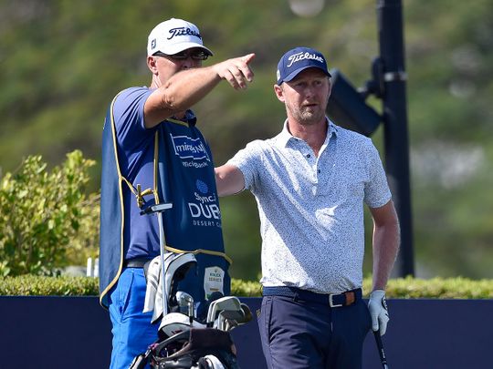 Justin Harding in discussion with his caddie at the Slync.io Dubai Desert Classic at Emirates Golf Club