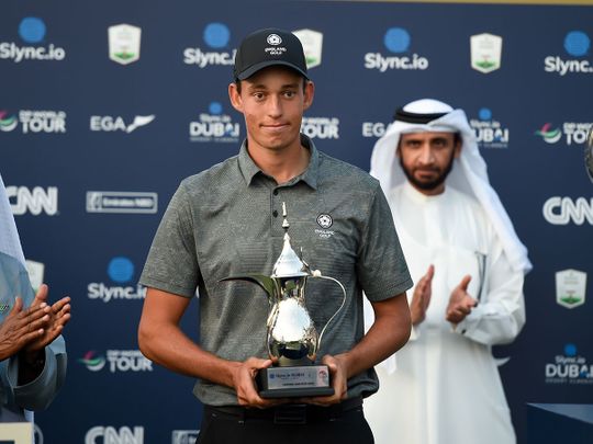 Dubai-based golfer Josh Hill receiving his award for top amatur at the Slync.io Dubai Desert Classic at Emirates Golf Club 