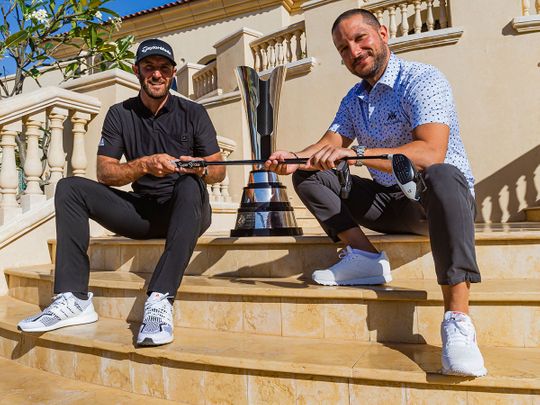 Dustin Johnson hands his clubs over to Royal Greens GM Mostapha Mneimneh