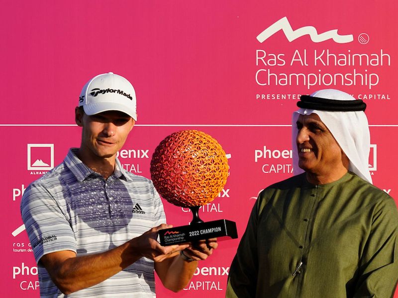 Nicolai Hojgaard receives the Ras Al Khaimah Championship trophy with Sheikh Saud bin Saqr Al Qasimi, member of the Supreme Council and ruler of Ras Al Khaimah