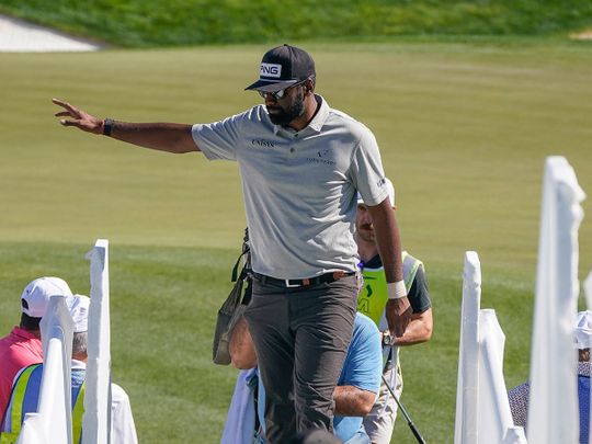 Sahith Theegala waves to fans after finishing up his round