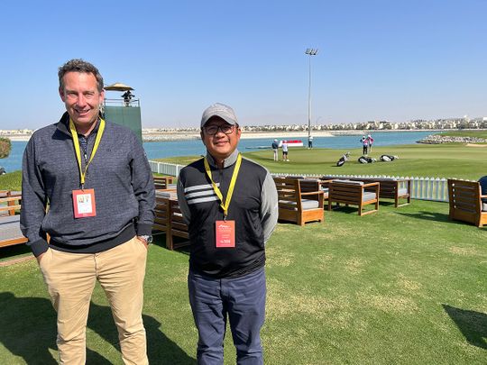 Superintendent Dindy Macaplang (right) alongside Troon's Clinton Southorn behind the 18th green at Al Hamra Golf Club.