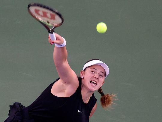 Jelena Ostapenko serves to Simona Halep during the semi-final Dubai Duty Free Tennis Championships