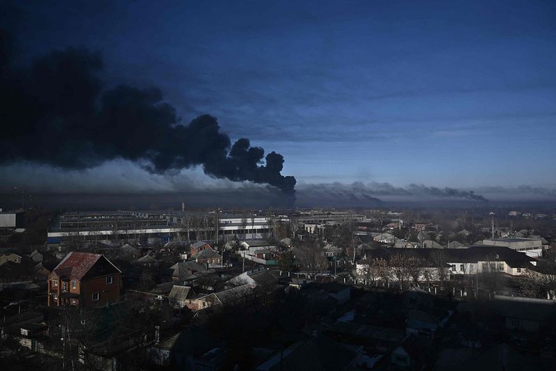 Black smoke rises from a military airport in Chuguyev near Kharkiv.