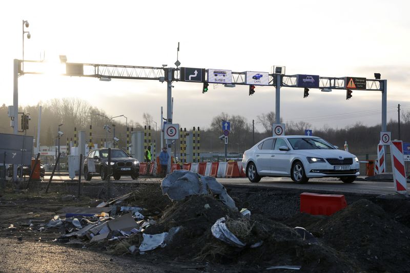 Cars drive at the border crossing between Poland and Ukraine, after Russian President Vladimir Putin authorized a military operation in eastern Ukraine. 