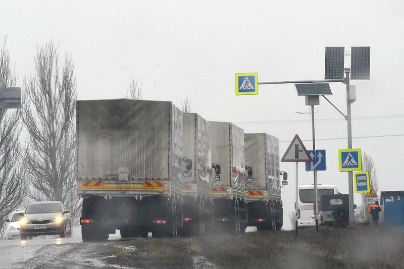 Trucks are seen on the side of a road near the border check point in Avilo-Uspenka. 