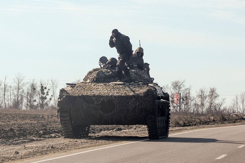 Ukrainian army soldier are seen on an armoured vehicle, after Russian President Vladimir Putin authorised a military operation, in eastern Ukraine, in Kharkiv region.