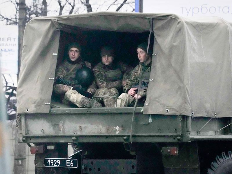 Ukrainian soldiers ride in a military vehicle in Mariupol, Ukraine, Thursday.