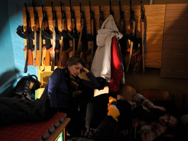 People hide in a bomb shelter in Kyiv in the early hours of February 25, 2022. 