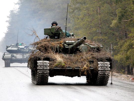 Ukrainian tanks move on a road before an attack in Lugansk region