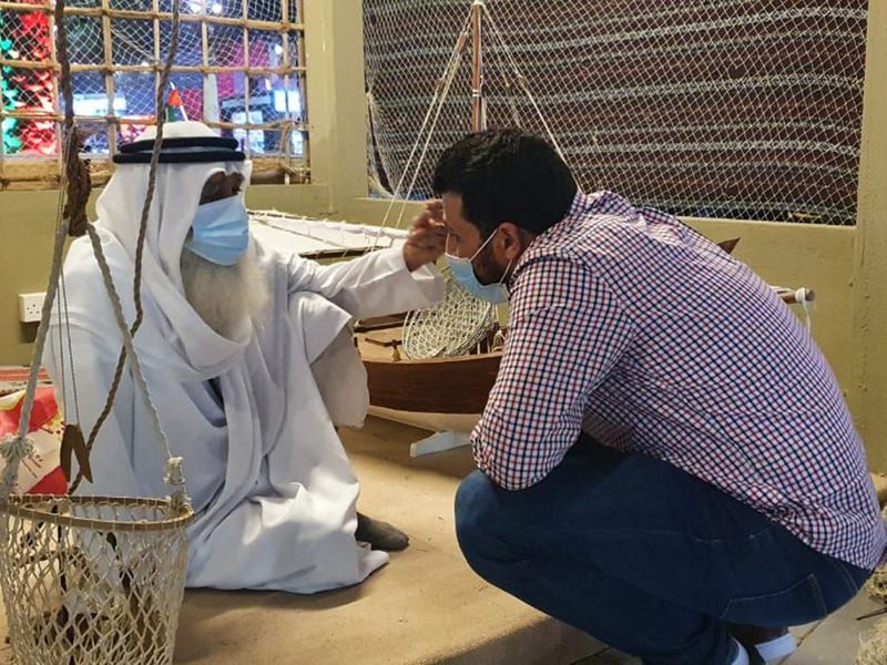 Ahmed Al Hammad recounts his pearl diving days with a visitor at Sheikh Zayed Festival 