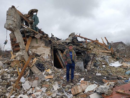 A Ukrainian man stands in the rubble in Zhytomyr