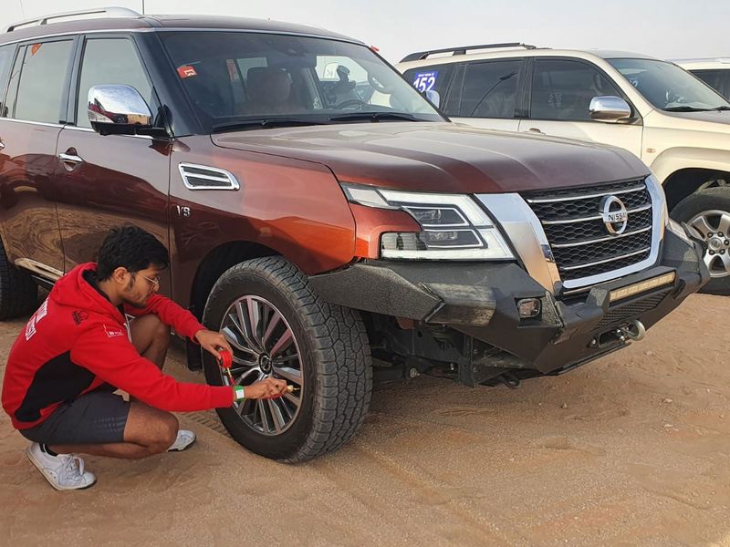 A participant deflating the tyre before hitting the desert.  
