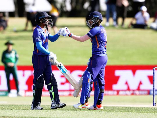 India's Pooja Vastrakar and Sneh Rana bump gloves during the Women's Cricket World Cup match against Pakistan