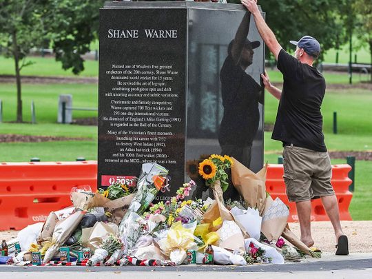 A mourner pays respects to Shane Warne outside Melbourne Cricket Ground 