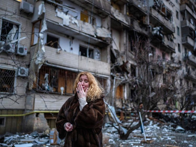 A woman reacts next to her house following a rocket attack the city of Kyiv, Ukraine. 