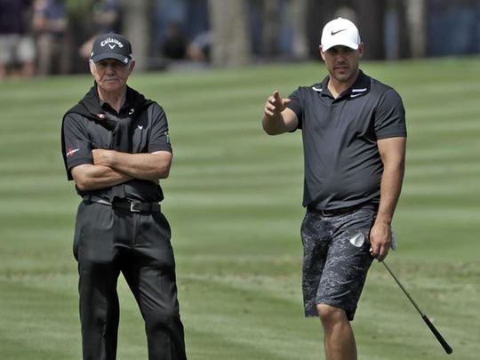 Peter Cowen on the course with Brooks Koepka