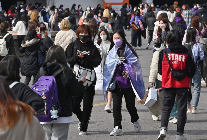 Fans of K-pop group BTS arrive for a BTS live concert at Jamsil Olympic Stadium in Seoul on March 10, 2022.