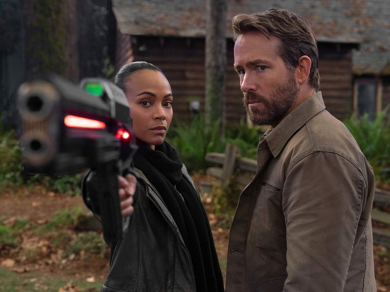 This image released by Netflix shows Zoe Saldana, left, and Ryan Reynolds in a scene from 