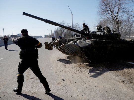 Ukrainian servicemen drive off in a Russian tank they captured after fighting with Russian troops, outside Brovary, near Kyiv. 
