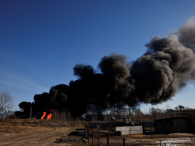 A column of smoke rises from burning fuel tanks that locals said were hit by five rockets at the Vasylkiv Air Base, outside Kyiv, on March 12, 2022. 