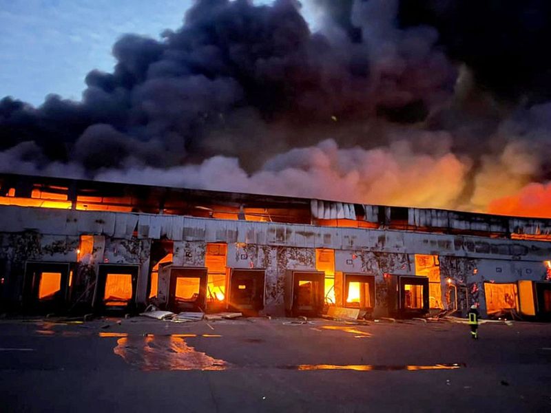 A warehouse storing frozen products is seen on fire after Russian shelling, in the village of Kvitneve in Kyiv region. 