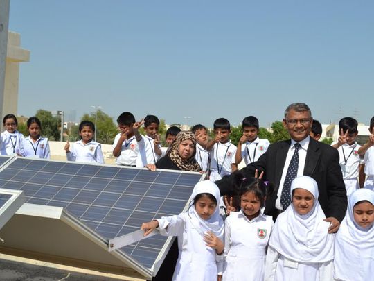 Mir Anisul Hasan with students following the installation of a solar panel-1647062518241