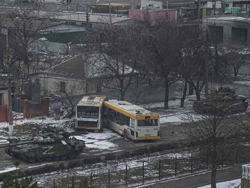 Russian's army tanks move down a street on the outskirts of Mariupol, Ukraine.